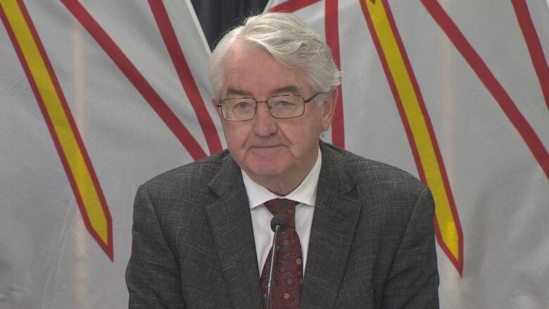 Older man with white hair in suit