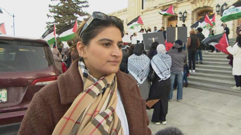 Tayyaba Farooq and others rallied inside and outside the Saskatchewan legislature Monday, calling for a cease fire in Gaza.