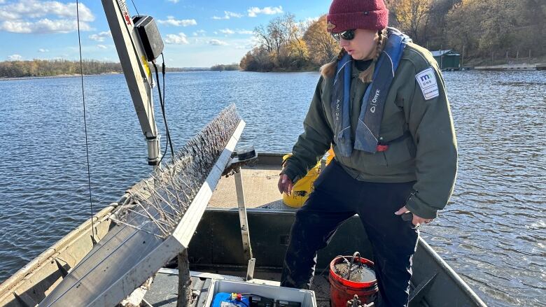 Minnesota Department of Natural Resources Invasive Carp Field Lead Kayla Stampfle inspects the components of a telemetry receiver that tracks tagged invasive carp in the Mississippi River near La Crosse, Wis. on Monday, Nov. 6, 2023. The solar-powered receiver can transmit real-time notifications of the movements of tagged invasive carp. 