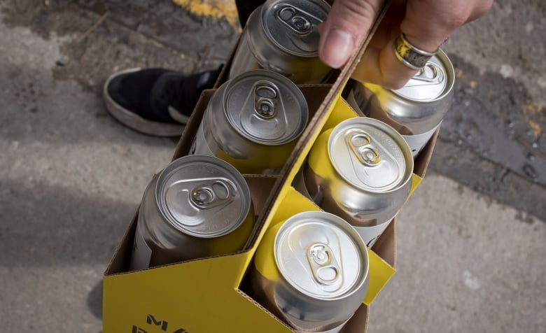 Six tall boy cans of beer. 