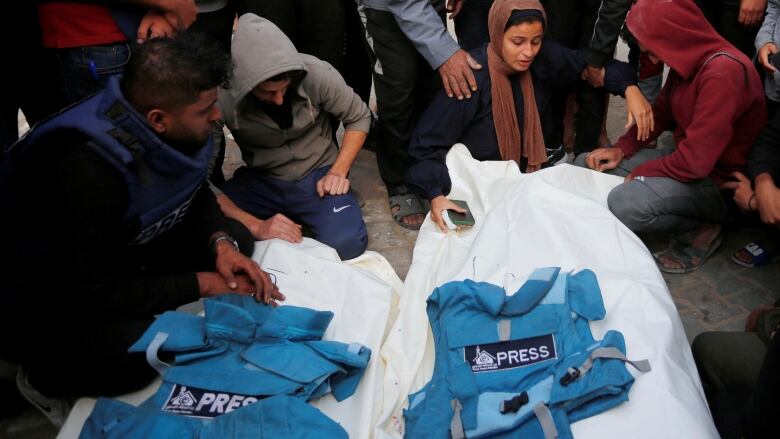 Palestinians mourn local journalists Hassouna Sleem and Sary Mansour, who were killed in an Israeli strike on a house, at a hospital in the central Gaza Strip November 19, 2023. 