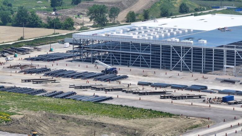 An aerial view of large industrial buildings under construction.