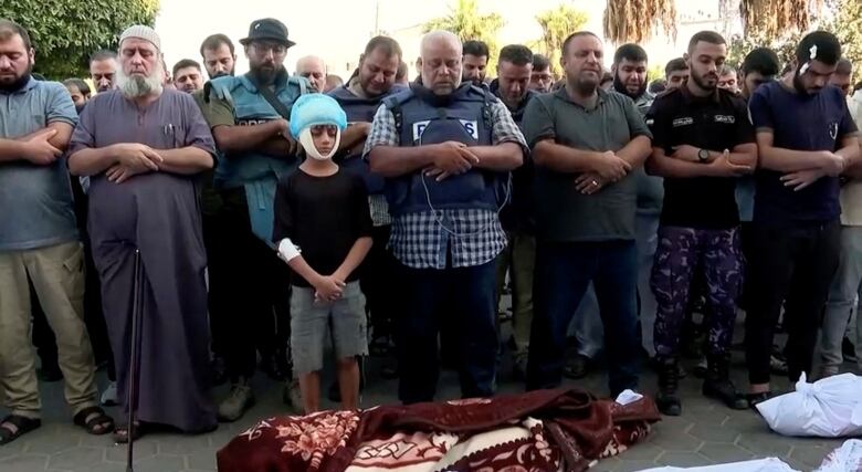 Al Jazeera correspondent, Wael Al-Dahdouh attends the funeral of his wife and children, who the network said were killed in an Israeli air strike, in central Gaza Strip, in this still image taken from a video obtained by Reuters on October 26, 2023. 