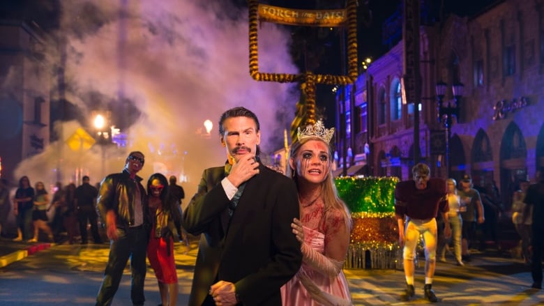 Standing next to a woman, a man dressed as the main character Rhett Butler from the classic film Gone with the Wind, during Halloween.