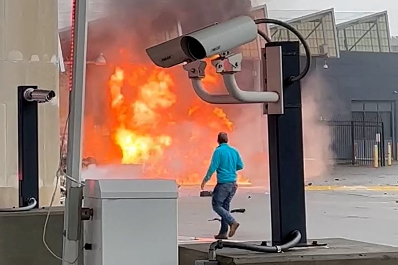 A vehicle burns at a border crossing station.