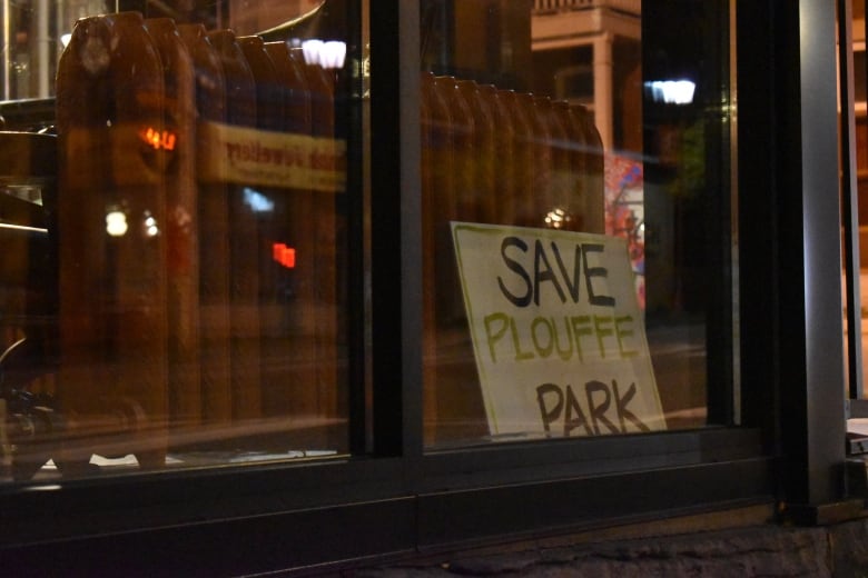 A sign in a window at night.