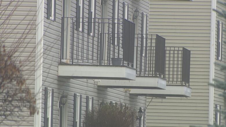 Apartment building balconies are shown in silhouette.