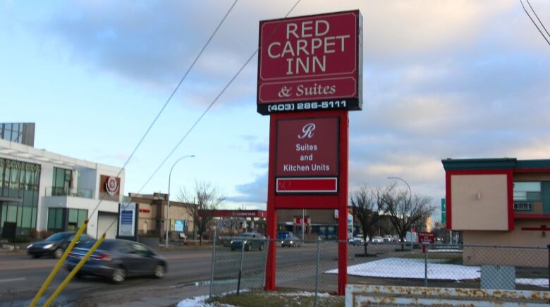 A sign is pictured that reads Red Carpet Inn and Suites.