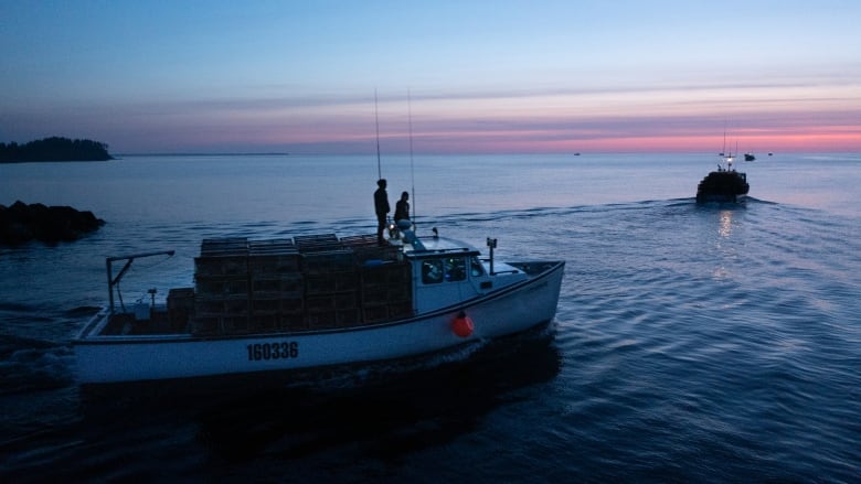 A lobster boat heading out loaded with traps seen from the drone 