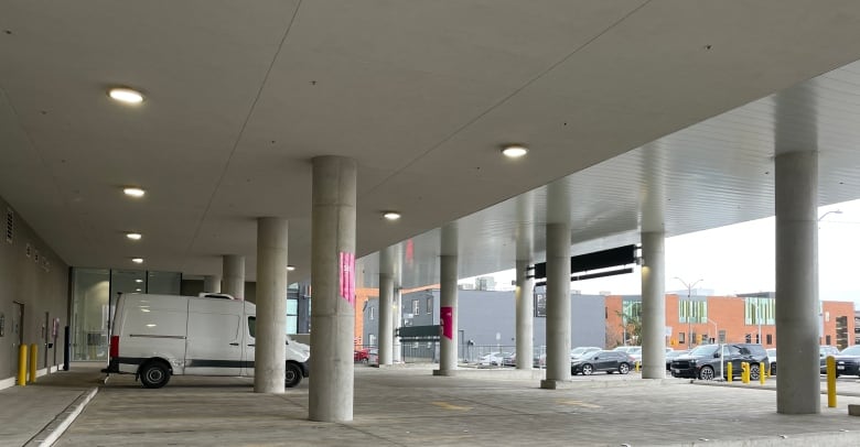 Cement columns hold up part of a building that allows for covered parking