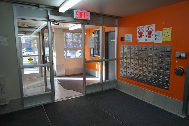 Apartment building lobby with mailboxes.