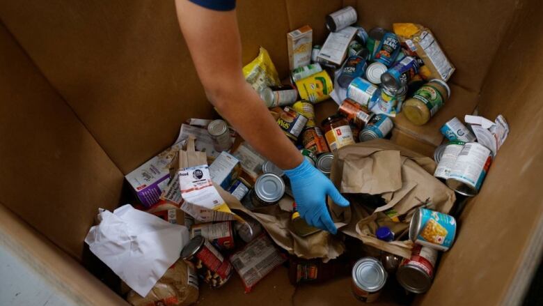 A volunteer sorts through donated groceries at Daily Bread Food Bank in Toronto, Ontario.