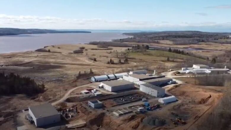 An aerial shot shows the several different buildings of the land-based salmon farm.