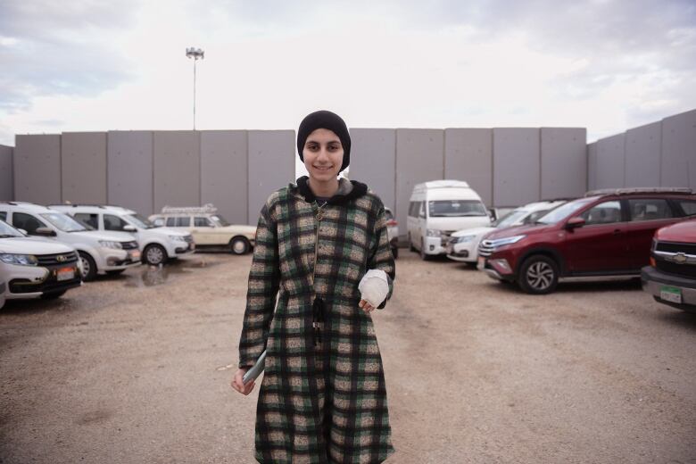 An injured teenage girl is seen at a border crossing.