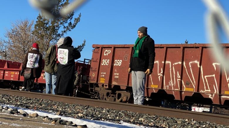 People standing on rail tracks