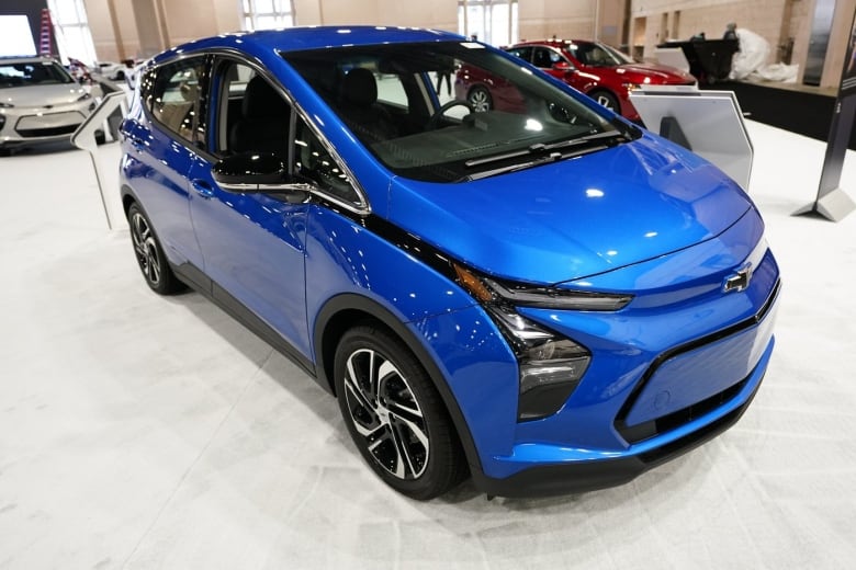 A blue car in a showroom