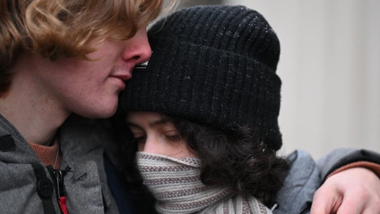 Two people hug outside the Russian Supreme Court building in Moscow.