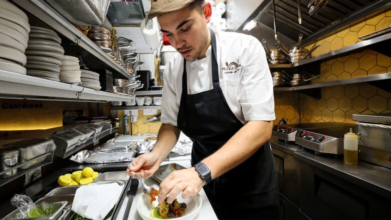 Chef Davide Sanna works in the kitchen of Piccola Cucina in New York's SoHo area.