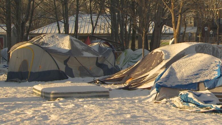 Tents covered in snow.