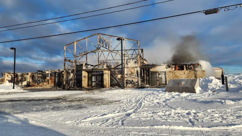 The remains of a building still stand after a fire.