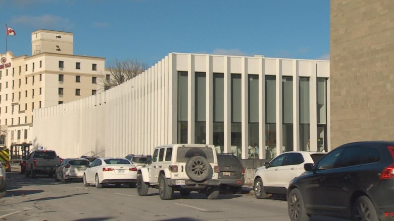 A modern-looking building, with cars driving by