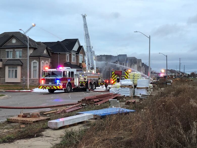 Crews respond to a fire at a new housing development on Monday morning on Lodi Street in Burlington in the area of Dundas Street and Walkers Line.