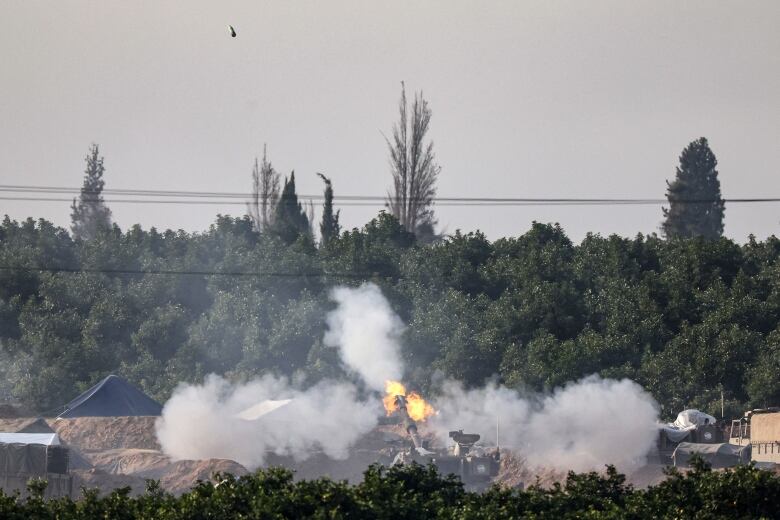 A tank fires a round. 