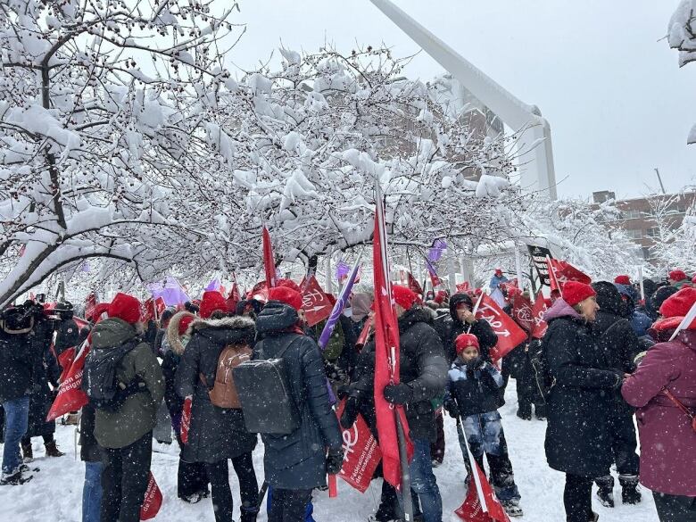 People stand outside in the snow.