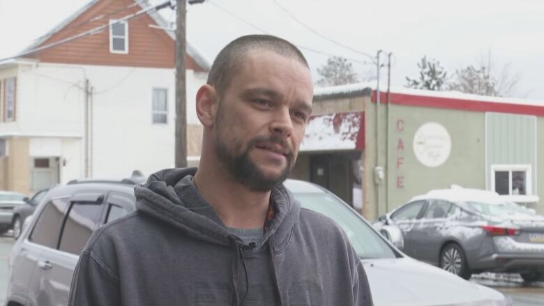 Doug Harper stands on the street