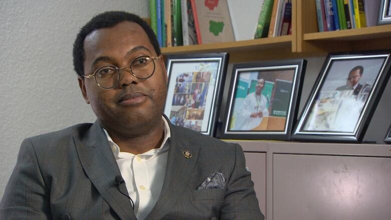 A man in a suit sitting in an office