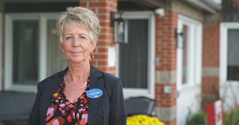 Lori Norris-Dudley, president and CEO of Osgoode Care Centre, stands in front of the main building in Oct. 2023.