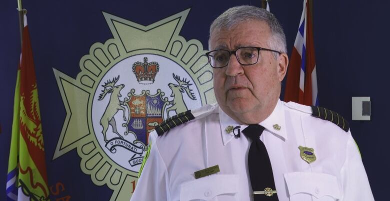 grey haired man in white uniform. 