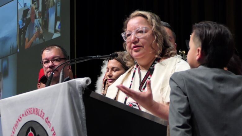 A politician speaks at a podium.