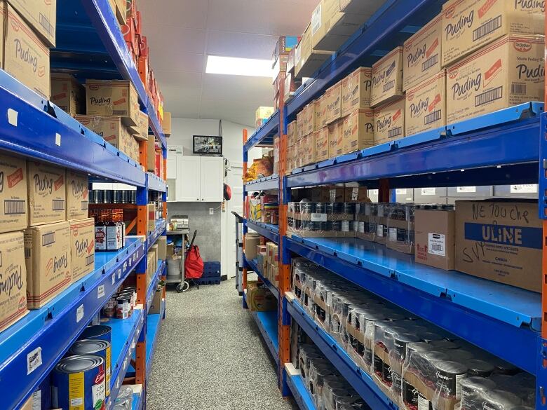 Donations line the shelves of the West Island Assistance Fund food bank in Montreal. 