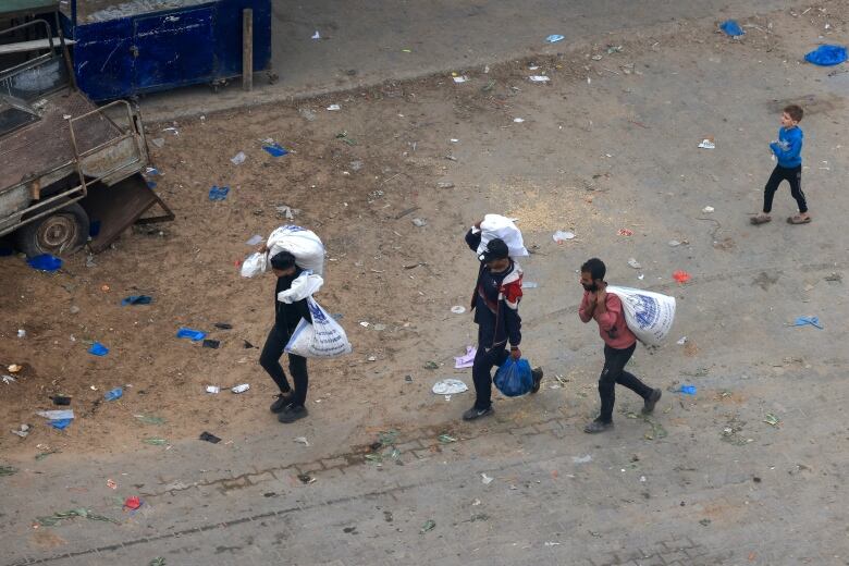 People are seen carrying bags.