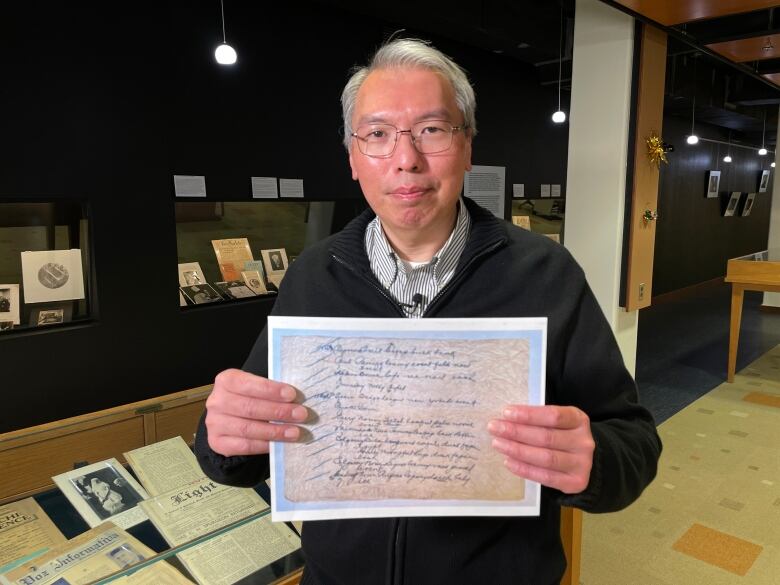 University of Manitoba research computer analyst holds a copy of the Silk Dress cryptogram.