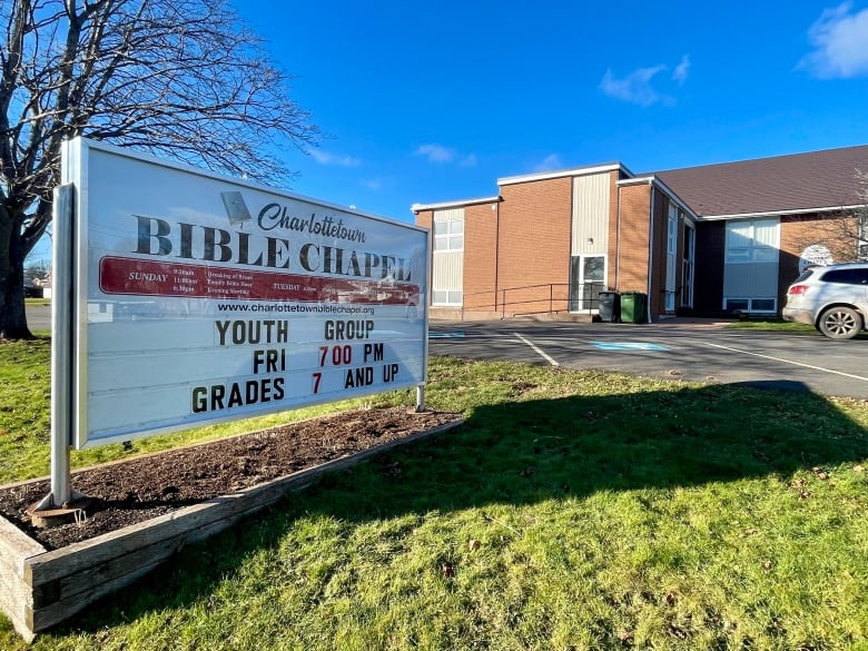 A sign reading Charlottetown Bible Chapel in front of a building. 