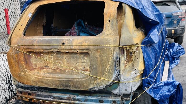 A burned out car with no back window.