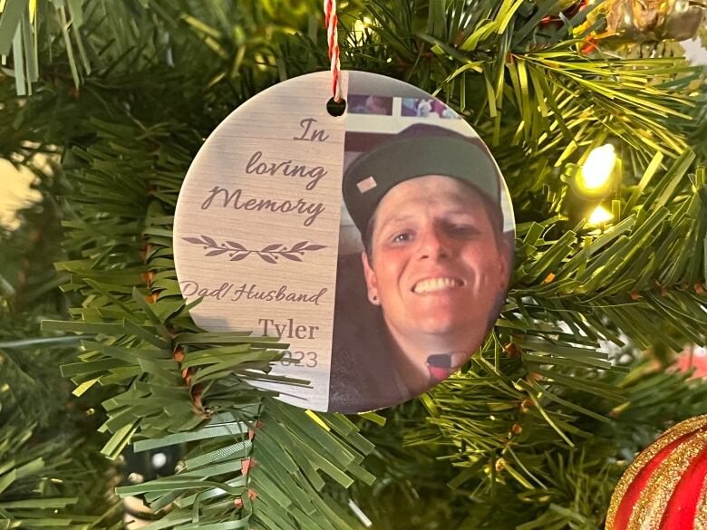 A tree ornament show a photo of Tyler Knockwood with the words, 