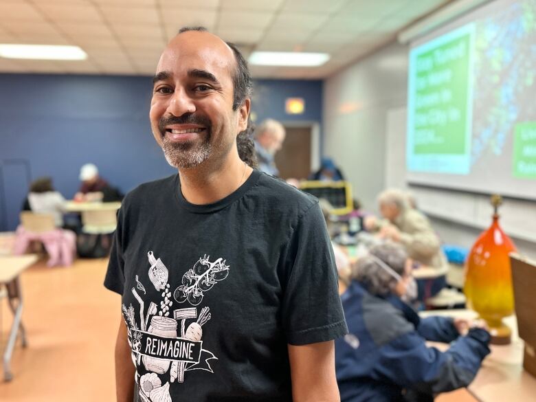 person smiles wearing t-shirt