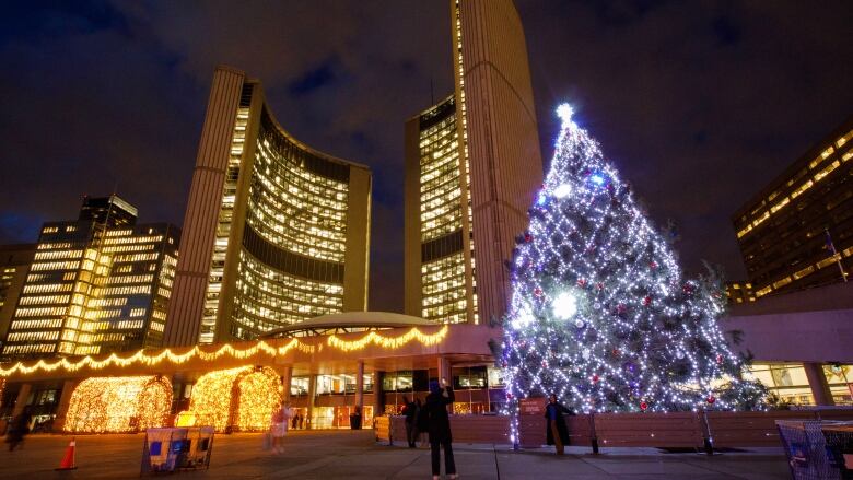 Giant lit Christmas tree near the front entrance of Nathan Phillips Square.