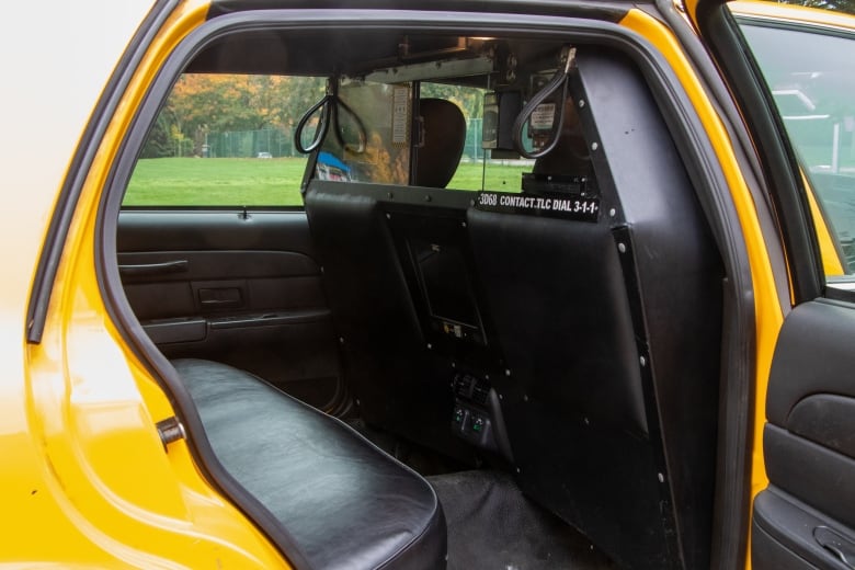 The interior of a yellow taxicab.