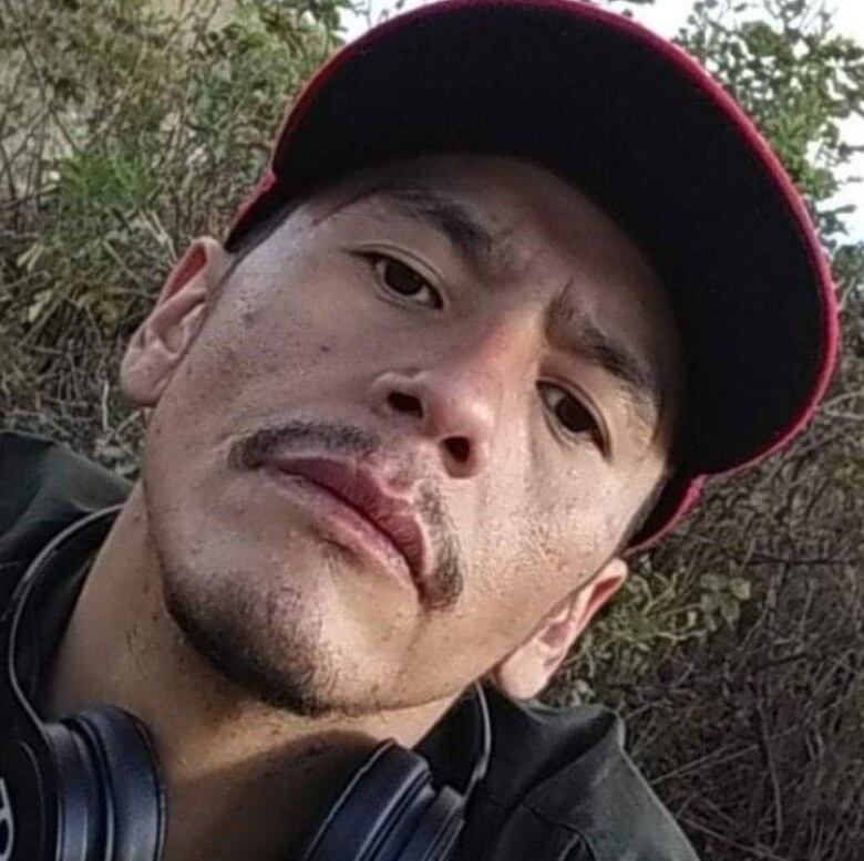 A closeup of a man wearing a baseball cap.