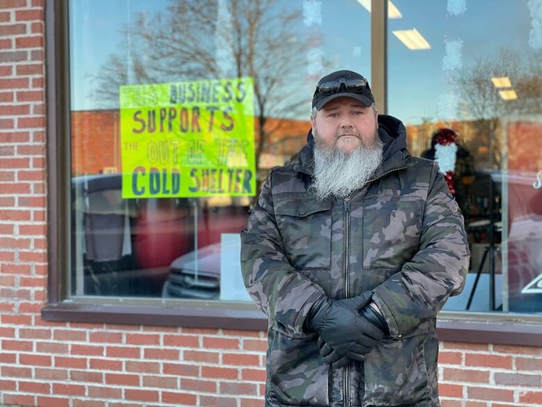 Vince Mullin in front of sign saying 