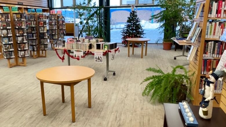 Bookshelves and tables inside a small public library.