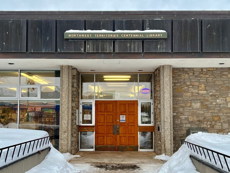 The front doors of a public building, in a snow. 