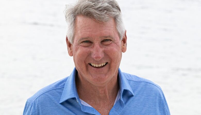 A man stands on a beach.