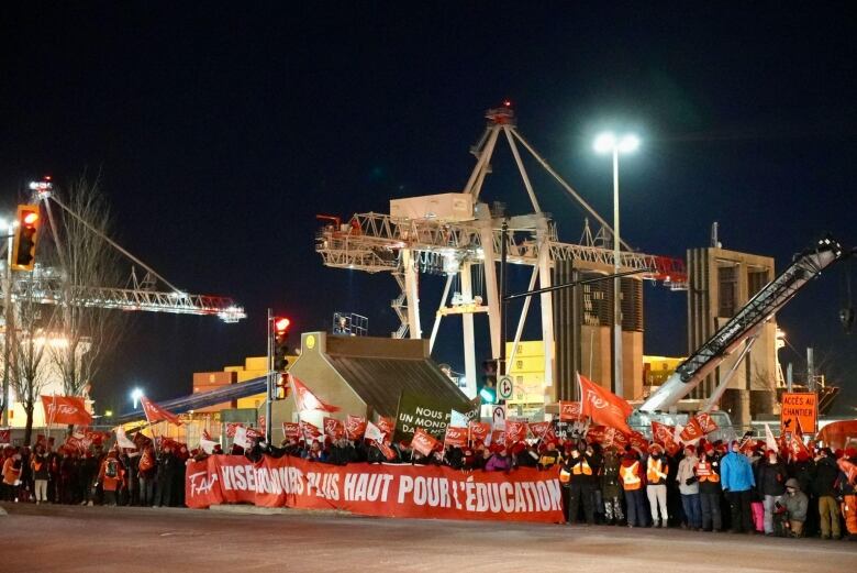 teachers blocking a port with banners and picket signs