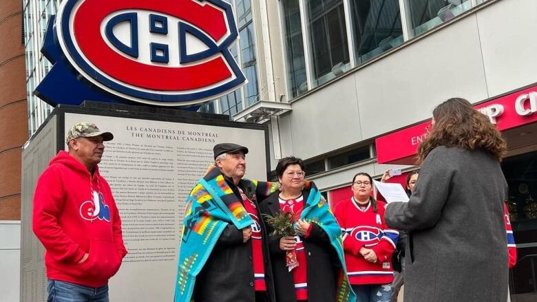 A moose-cree couple dressed in Montreal Canadians fan gear get married outside Bell Centre. 