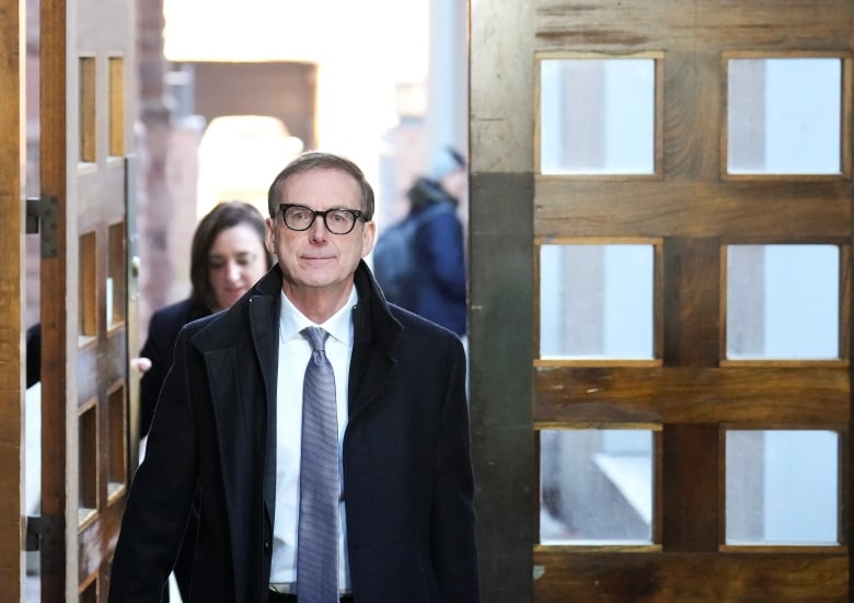 A man walks through a doorway.